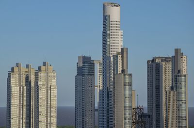 Skyscrapers in city against clear sky