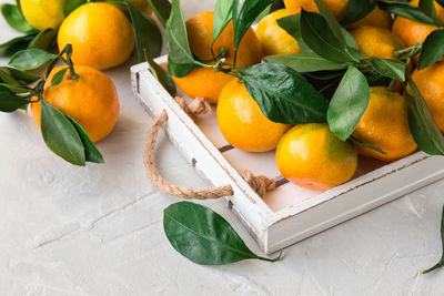 High angle view of fruits and leaves on table