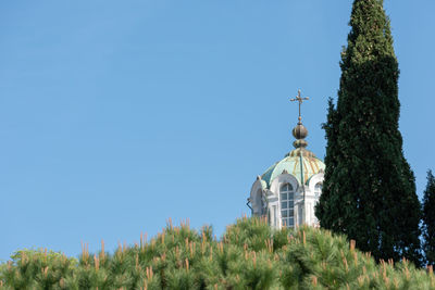 Low angle view of cross against clear blue sky