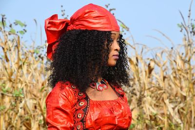 Woman with curly hair standing on field
