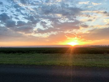 Scenic view of field against sky during sunset