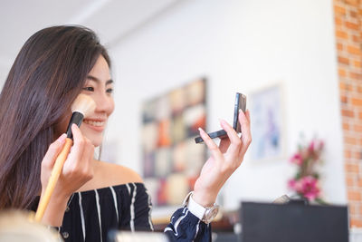 Portrait of young woman using mobile phone