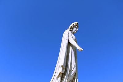 Low angle view of statue against clear blue sky