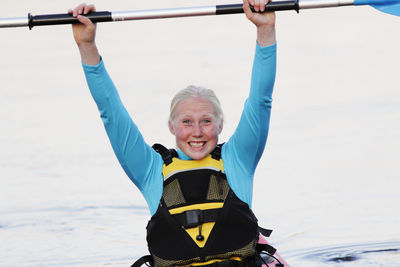 Smiling woman holding paddle