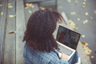 Rear view of woman using mobile phone