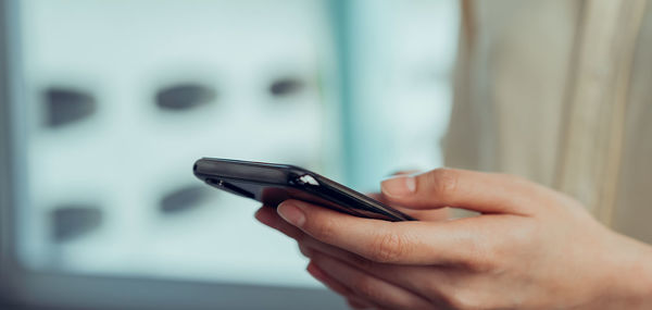 Midsection of man using mobile phone