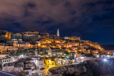 Illuminated cityscape against sky at night