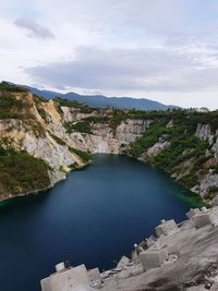 Scenic view of river amidst mountains against sky