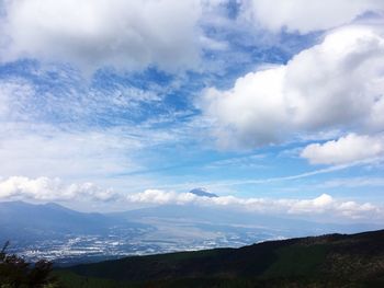 Scenic view of mountains against cloudy sky