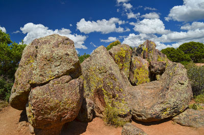 Rocks on field against sky
