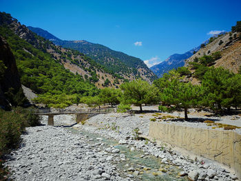 Scenic view of mountains against blue sky