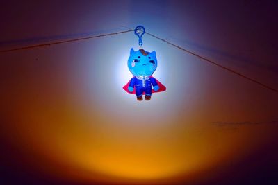 Low angle view of hanging light against sky