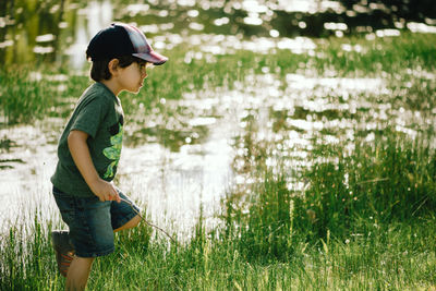 Side view of boy on field