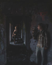 Young man standing against wall