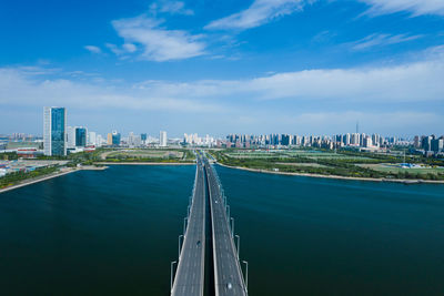 Panoramic view of bridge and buildings against sky