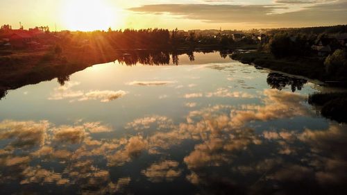 Scenic view of lake against sky during sunset