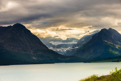 Scenic view of lake and mountains against sky