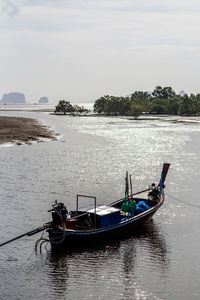 Boats moored in sea against sky