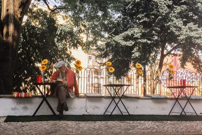 Man standing by tree in city