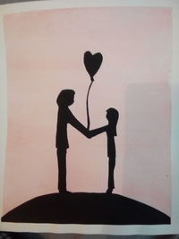 Silhouette couple standing against heart shape