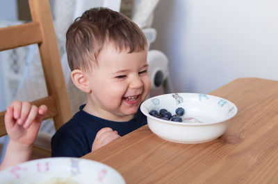 Siblings fooling around at the breakfast table