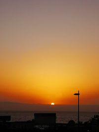 Scenic view of sea against orange sky