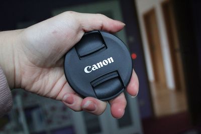 Close-up of human hand holding camera