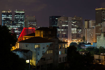 High angle view of buildings lit up at night