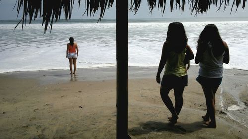 Rear view of people on beach