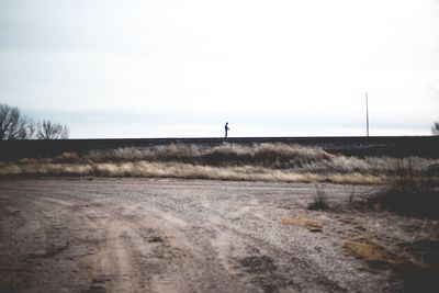 Man on road against sky