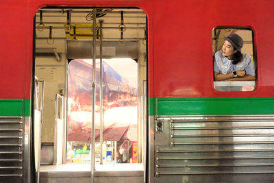 Woman leaning from train window