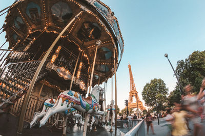 Low angle view of carousel against sky