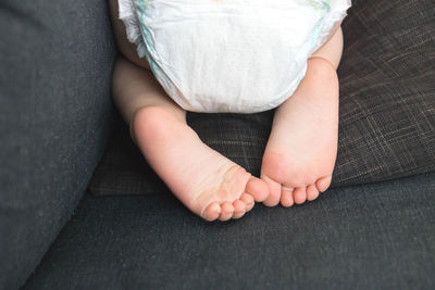 Low section of baby on sofa