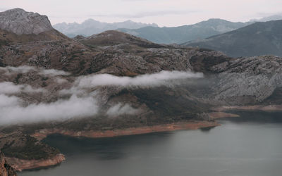 Scenic view of lake and mountains against sky