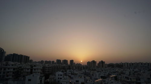 Cityscape against sky during sunset