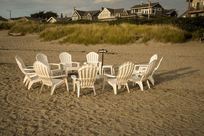 Chairs on sand at beach