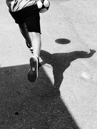 Low section of woman walking on street