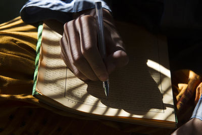 Close-up of hand holding book