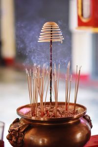 Close-up of tea light on table in building