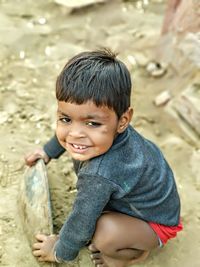 Portrait of smiling boy playing at beach