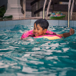 Young boy swimming in pool