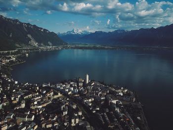 Aerial view of lake and buildings against sky