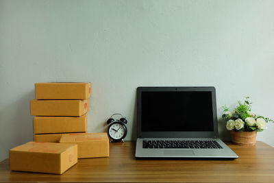 Electric lamp on table against wall