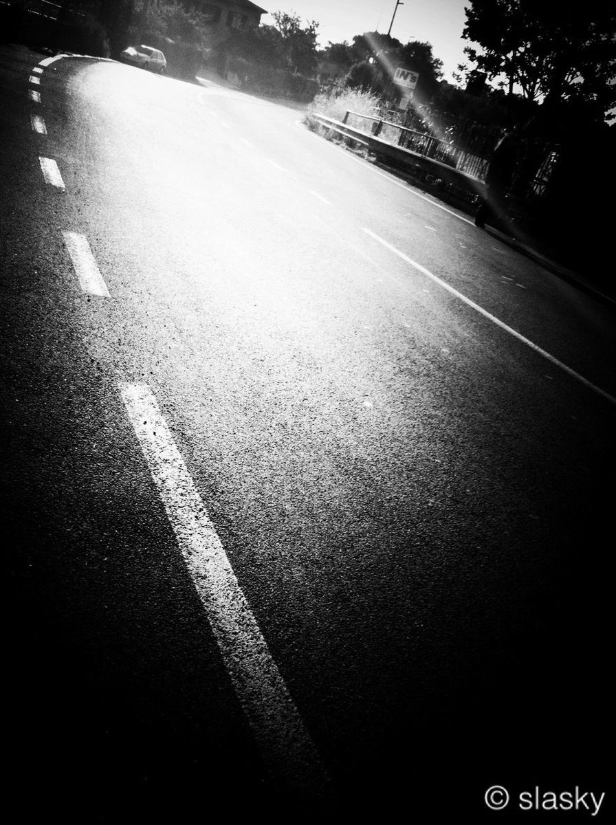 transportation, road, road marking, street, the way forward, asphalt, tree, car, diminishing perspective, shadow, sunlight, vanishing point, land vehicle, mode of transport, day, outdoors, empty road, high angle view, empty, no people