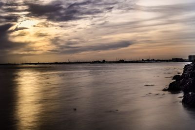 Reflection of clouds in sea at sunset