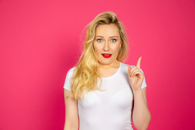 Portrait of beautiful woman against red background