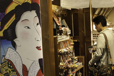 Rear view of man standing in store
