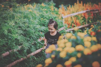 Cute girl amidst plants
