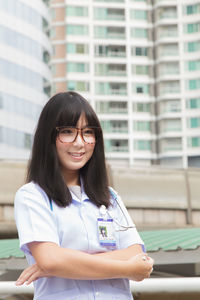 Young female doctor standing in city