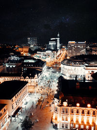 High angle view of illuminated buildings in city at night
